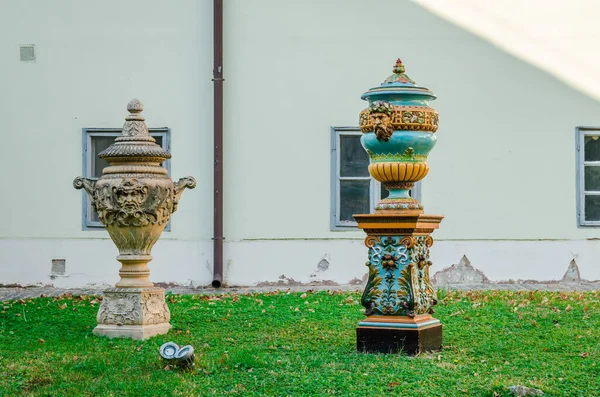 Pecs, Hungary - October 6, 2018: Zsolnay Museum courtyard with sculptures of lions, deer, elephants and a blue vase in Pecs Hungary.