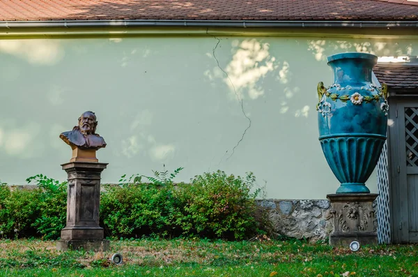 Pecs, Hungary - October 6, 2018: Zsolnay Museum courtyard with sculptures of lions, deer, elephants and a blue vase in Pecs Hungary.