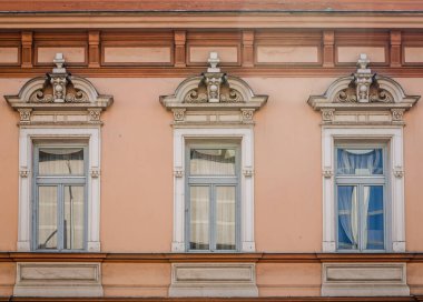 Pecs, Hungary - October 06, 2018: Windows with decorative baroque facades in the center of Pecs, Hungary