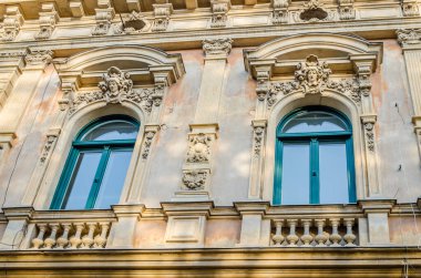Pecs, Hungary - October 06, 2018: Windows with decorative baroque facades in the center of Pecs, Hungary