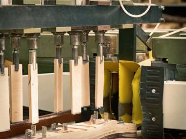 A closeup of a woodworking machine in a factory. Grinding and shaping process.