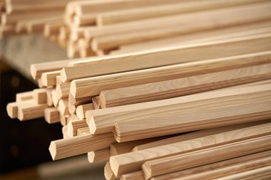 A closeup of many wooden blanks for making furniture in a carpenter's workshop. Industrial background.