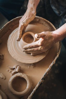 Clay modeling hands on a potter's wheel. Handmade. Ceramic tableware.