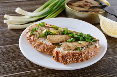 Tütsülenmiş sprat, tereyağı ve yeşil soğanlı sandviçler. Danimarka mutfağı..