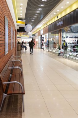 Poltava, Ukraine - January 04, 2022: Big modern trade centre. People go shopping. Vertical view.