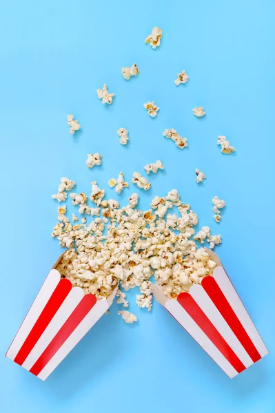 Popcorn Spills Out Paper Striped Cups Blue Background Splash Popcorn — Stock Photo, Image