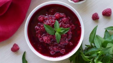 Tasty raspberry jam. Top view. Camera move around bowl. Healthy organic food.