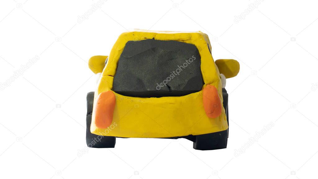 Plasticine in the shape of a yellow car. Rear view of a child-like hand-crafted car. On isolated white background with clipping path.