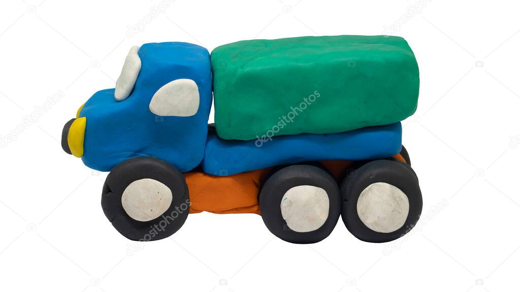 Plasticine in the shape of a Truck car. Beside view of a child-like hand-crafted car. On isolated white background with clipping path.