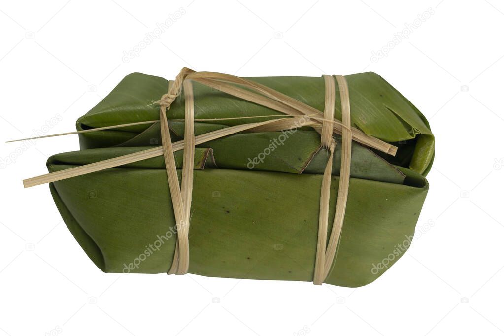 Thai dessert name Bundled boiled rice. wrapped in banana leaves and use two pieces to join them together as a pair. On isolated white background with clipping path.