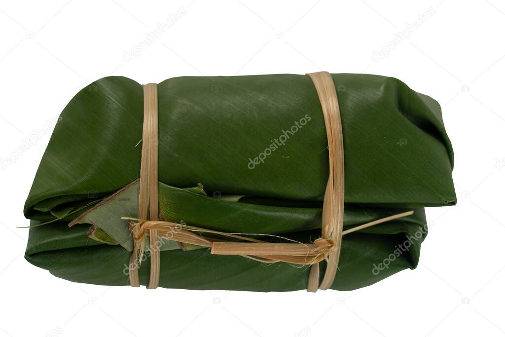 Thai dessert name Bundled boiled rice. wrapped in banana leaves and use two pieces to join them together as a pair. On isolated white background with clipping path.