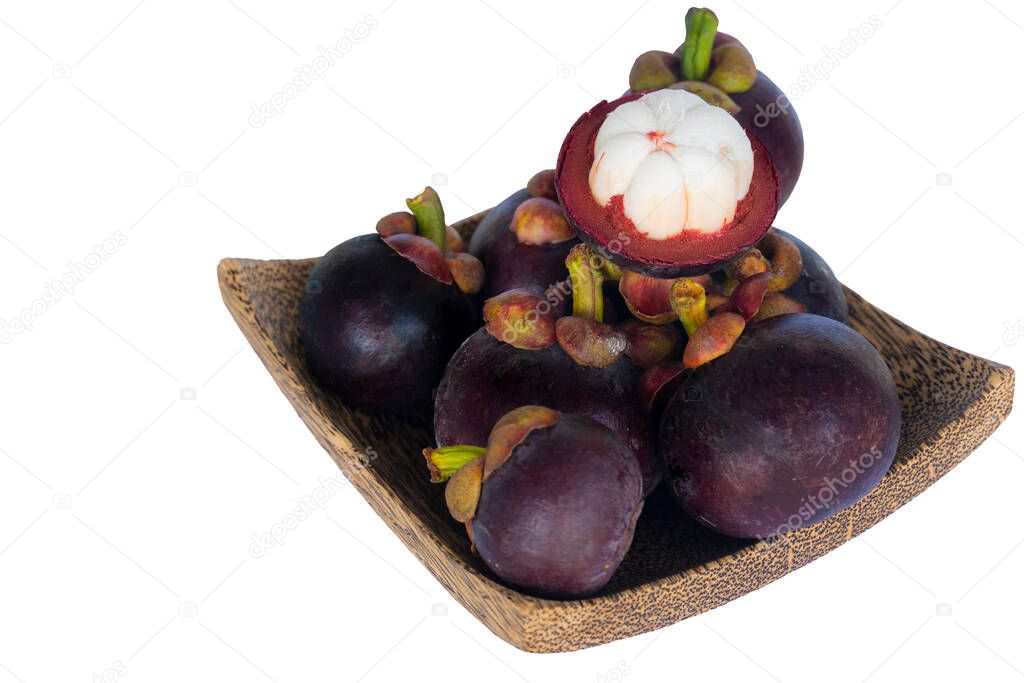 Textured of mangosteen fruit stacked in a wooden craft. Fruit that was cut once saw ripe, appetizing white flesh. on isolated white background.