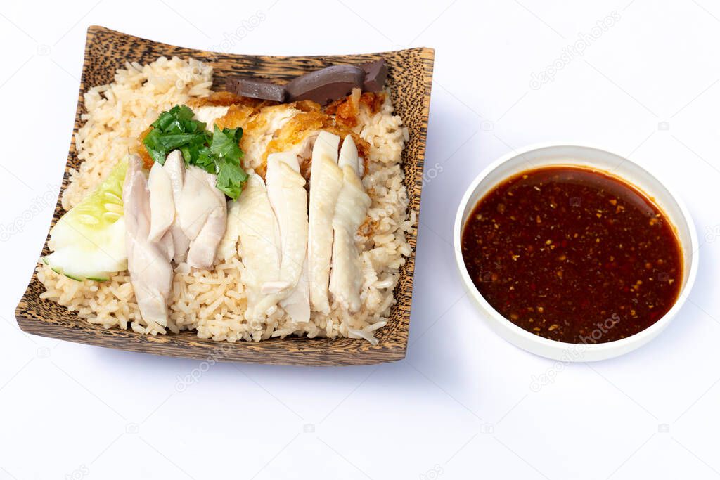 Hainanese chicken glutinous rice mix with Fried Chicken and sauce. Served in a coconut-patterned dish. On white floor or isolated white background.