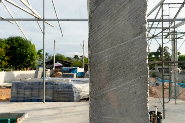 Plastic wrap cement pole. Blur background of house building materials.