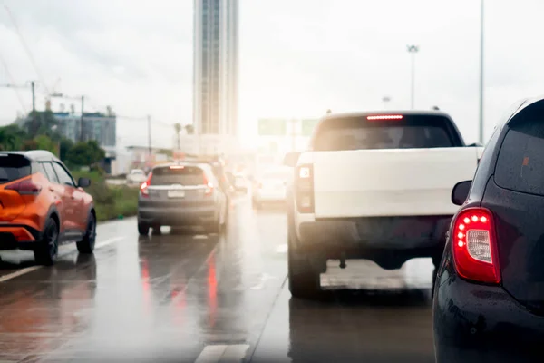 Abstract of rear back car. Rear side view of car in rainy time and traffic jam. Traffic congestion with many queues due to the wet asphalt road surface.