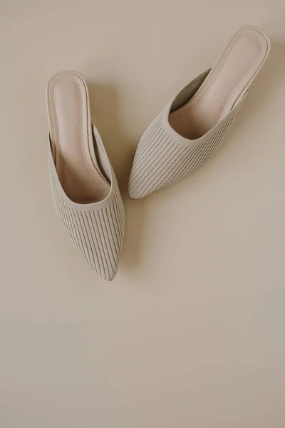 Beige fashion women\'s shoes on pastel beige background. Elegant luxury fashion concept. Flat lay, top view