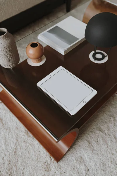 Tablet pad with blank screen on decorated coffee table. Aesthetic template with mockup copy space. Online store, blog, social media, website branding. Online shopping concept
