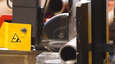 Endüstriyel metal kesme makinesi soğutucu ile metal borular kesiyor..