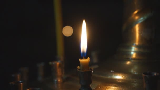 Lighting Wax Candles Inserted Sand Burning Temple Spreading Light Blurred — Stock Video