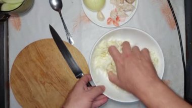 Kneading cabbage with salt for chicken salad