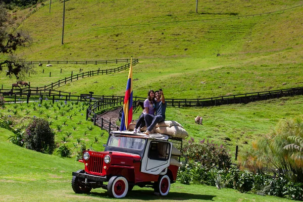 SALENTO, COLOMBIA - JULY 2021. Couple of tourists visiting the beautiful Cocora Valley located in Salento at the Quindio region in Colombia
