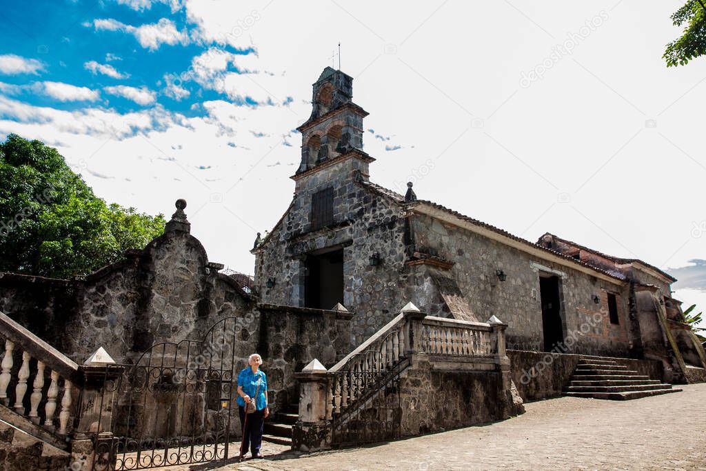 Senior woman at the beautiful historical church La Ermita built in the sixteenth century in the town of Mariquita in Colombia