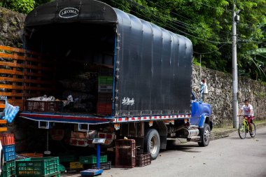 MARIQUITA, COLOMBIA - MAY, 2022: Unloading of a truck carrying fruits and vegetables in the town of Mariquita in Colombia
