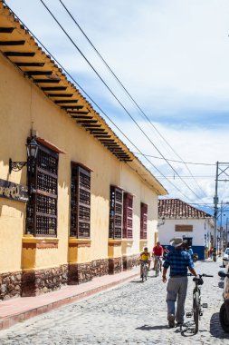 SANTA FE DE ANTIOQUIA, , COLOMBIA - NOVEMBER, 2017: Local man walking at th beautiful antique streets of the colonial town of Santa Fe de Antioquia in Colombia