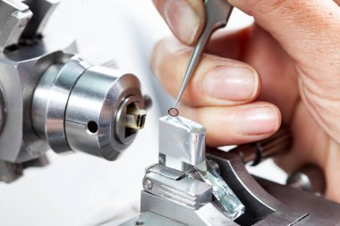 Closeup of a female scientist placing a sample on a transmission electron microscopy grid