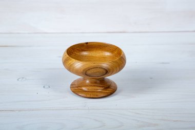 El yapımı ahşap masa takımı ve beyaz tahta arka planda parlak bir ciltli yüzey. Değerli ahşaptan yapılmış sofra takımı..