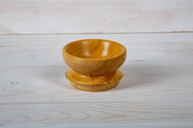 El yapımı ahşap masa takımı ve beyaz tahta arka planda parlak bir ciltli yüzey. Değerli ahşaptan yapılmış sofra takımı..