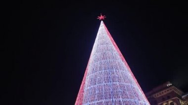 Milano 'daki Duomo' nun merkez meydanında binlerce renkli ampulden yapılmış modern bir yapay Noel ağacı. Yeni yıl için gece aydınlatması ve kış vakti Noel tatili.