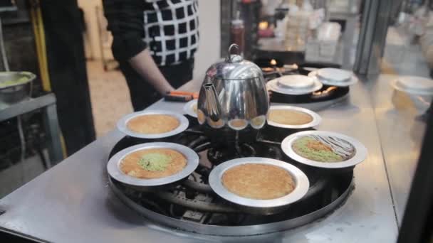 Chef koken een traditioneel Turks dessert op hete ijzeren plaat. Een zeer uniek dessert geserveerd met hete siroop. Beroemde Machaneh Yehudah markt in Jeruzalem, Israël — Stockvideo