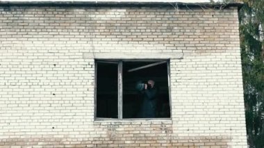 Terk edilmiş bir evde tanksavar silahı olan bir adam. Tankları yok etmek için silahlı sivil halk.