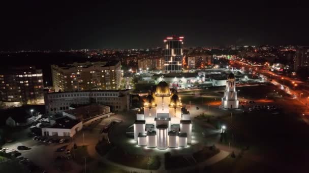 Vista panorámica del centro de la ciudad por la noche, Lviv, Ucrania. Vista superior desde el dron en la iglesia y campanario por la noche con casas y edificios en el fondo. Concepto de ciudad nocturna — Vídeos de Stock