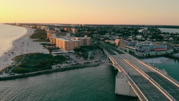 Johns Pass Madeira Beach AERIAL. Estrecho y paseo marítimo que está al sur de Florida en San Petersburgo. Estrecho y puente levadizo al atardecer. — Vídeo de stock