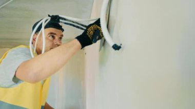 Repair work in the room. Plasterer painter construction worker plasters the wall with a plaster spatula. Plastering and leveling of unevenness on a wall by means of finishing plaster.