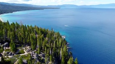 The amazing beauty of a high mountain lake in California. The nature and landscape of rocky mountains covered with snow and a crystal clear lake.