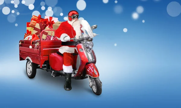 Papai Noel entrega presentes de Natal ou Ano Novo em scooter vermelho no fundo azul — Fotografia de Stock