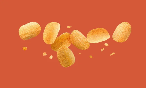 Potato chips flying on a red background. — Fotografia de Stock