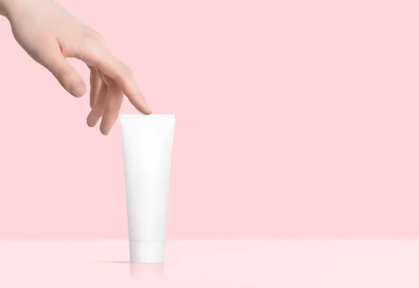 Female Hand Touches White Blank Tube Facial Hands Body Cream — Stok fotoğraf