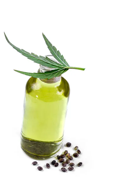 Ekologisk hampa vegetabilisk olja med blad och frön vit bakgrund — Stockfoto