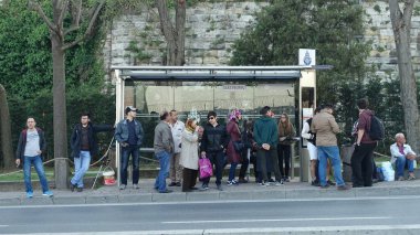 İstanbul, Türkiye - 23 Nisan 2018: Kalabalık gündüz otobüs durağında bekliyor 