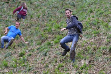 Yarışmacılar, Cooper 's Hill' deki geleneksel peynir yuvarlama yarışlarına 25 Mayıs 2015 'te Brockworth, İngiltere' de katılmaktadır. 19. yüzyıla dayanan onaylanmamış yıllık etkinliğe binlerce kişi katıldı..