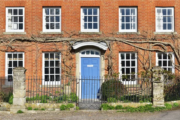 View of a front door and porch of a beautiful old town house on a street in an English city