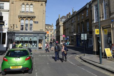 People pass along a street in the city centre on May 13, 2016 in Bath, UK. The Somerset city of Bath in England is a popular travel destination with 4 million tourist visitors each year.