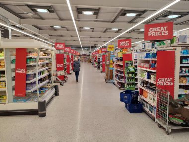 Products are seen on shelves in a Tesco supermarket aisle on December 12, 2014 in London, UK. Britain's Tesco is the world's third-largest supermarket after America's Walmart and France's Carrefour.