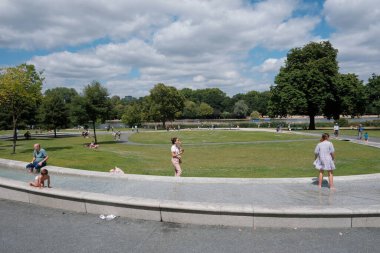 People visit a city centre park on July 7, 2022 in London, UK.