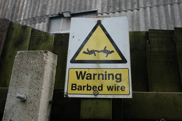 View Generic Sign Reading Warning Barbed Wire — Stock Photo, Image