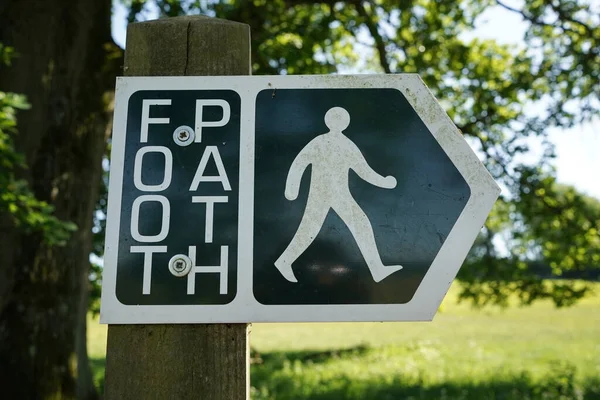 View of a generic public footpath sign on a forest trail